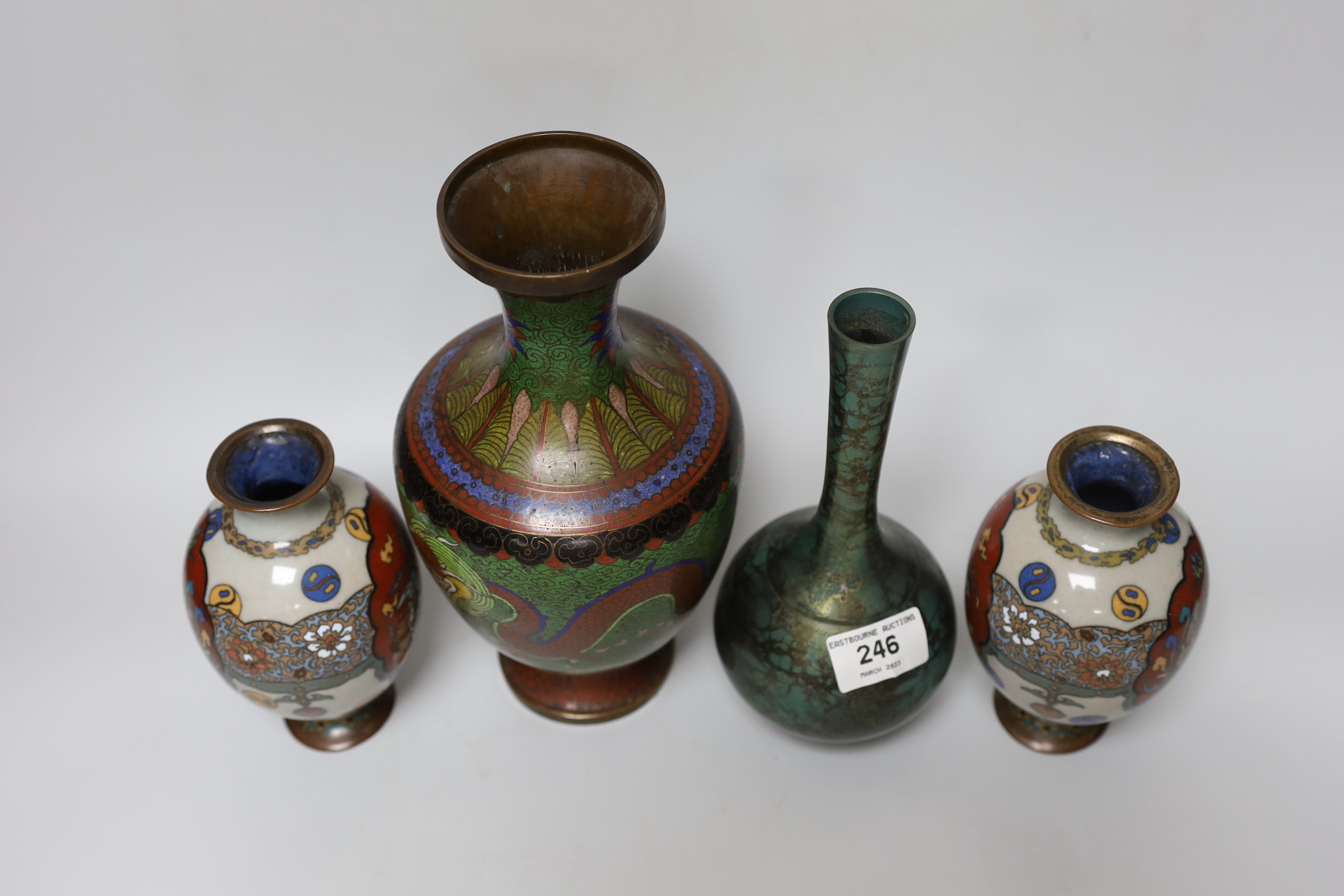 A pair of Japanese cloisonné enamel vases, a Chinese cloisonné enamel vase and a signed mottled bronze bottle vase, tallest 26cm